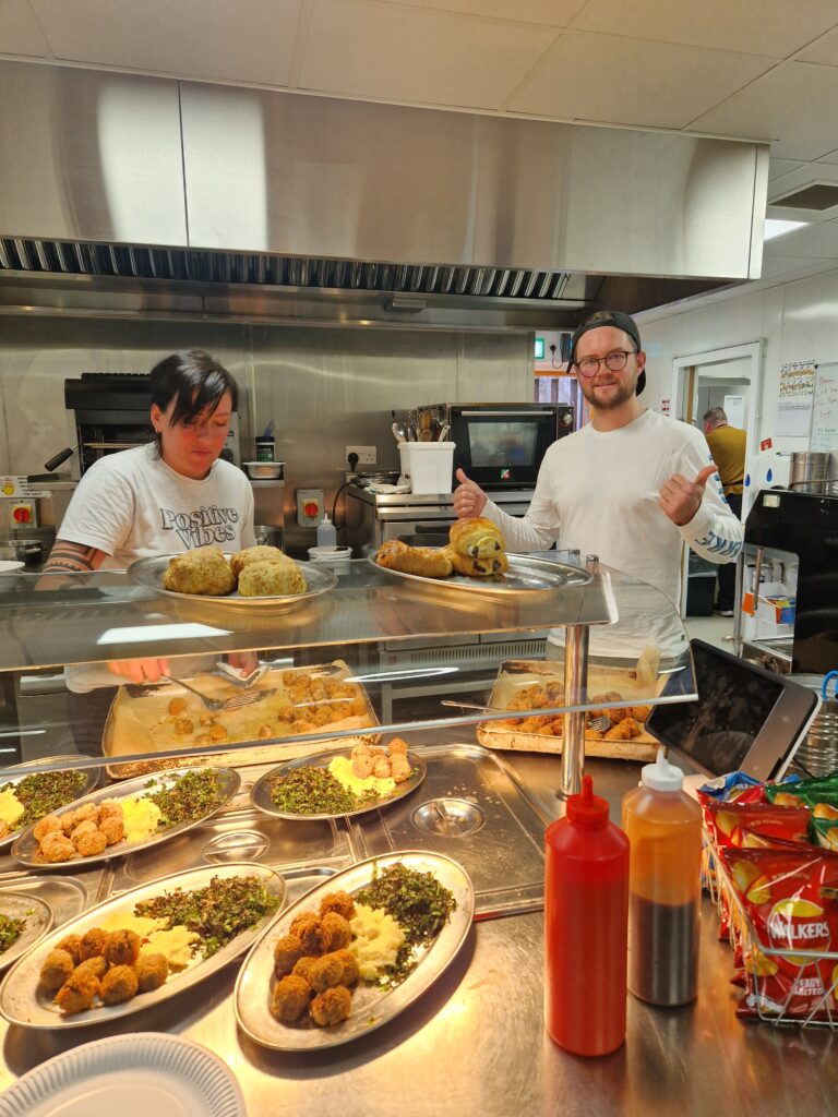 Fin and Magda serving up food from the cafe at our Pirate Brunch Community Meal.