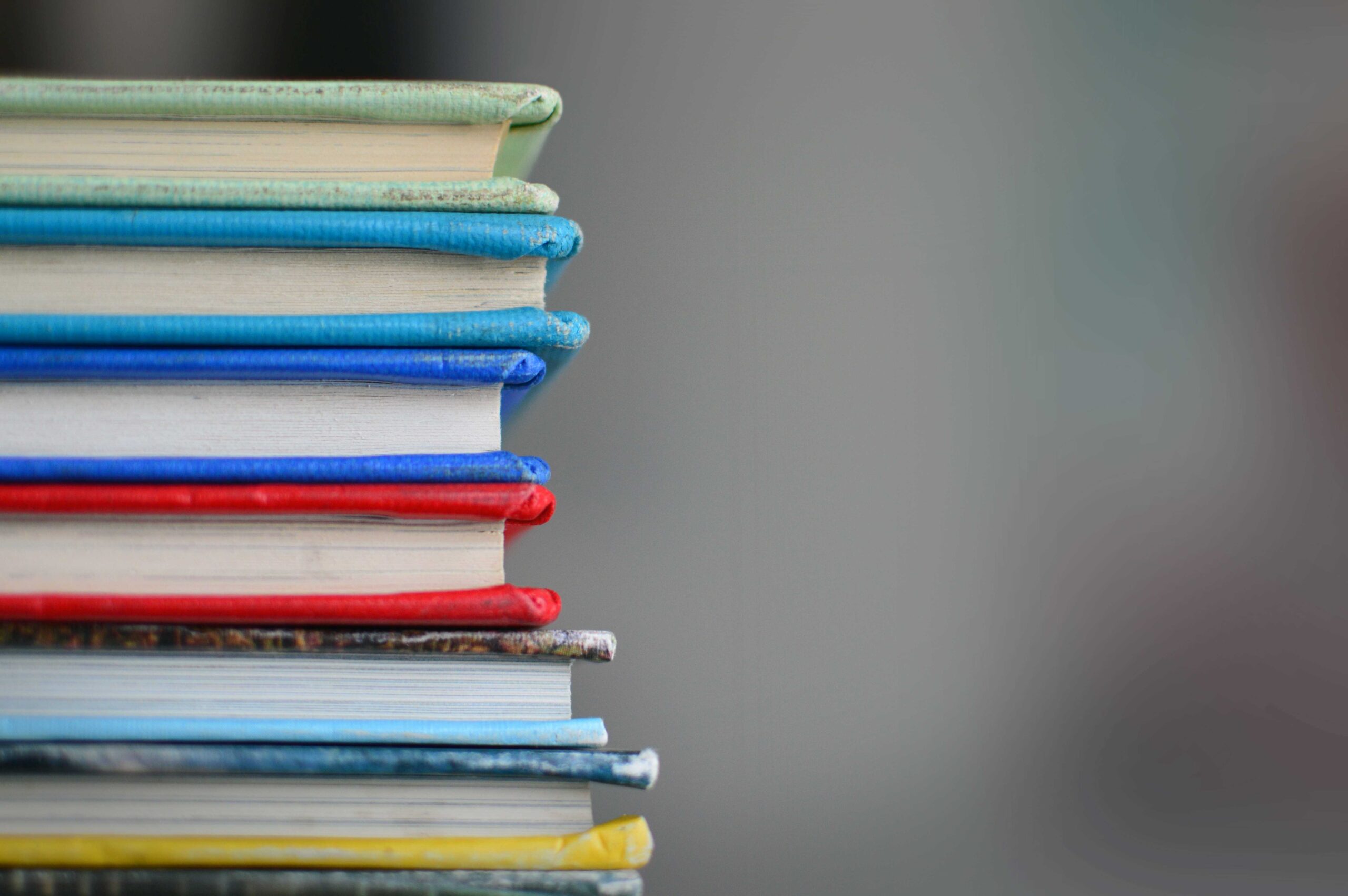 stack of six hardcover books of different colours